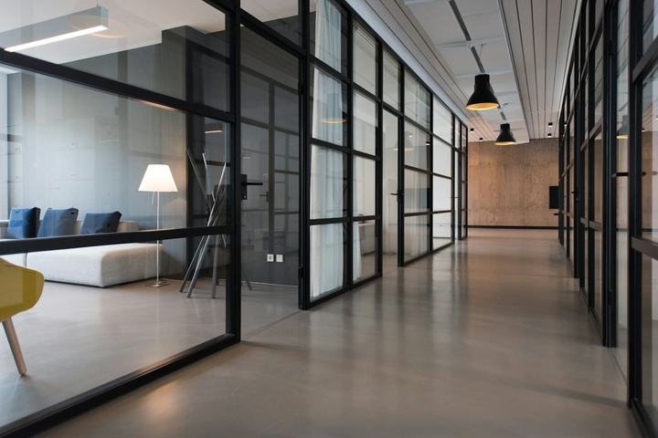 Renovated office interior with glass-walled rooms along a corridor